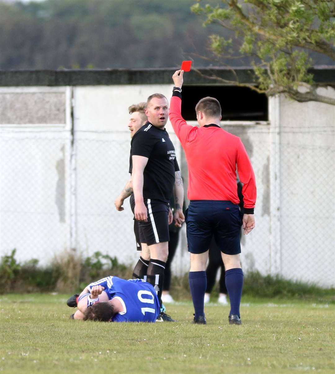 Watten player/manager Stuart Sinclair is red-carded for a heavy challenge on Andy Falconer. Picture: James Gunn