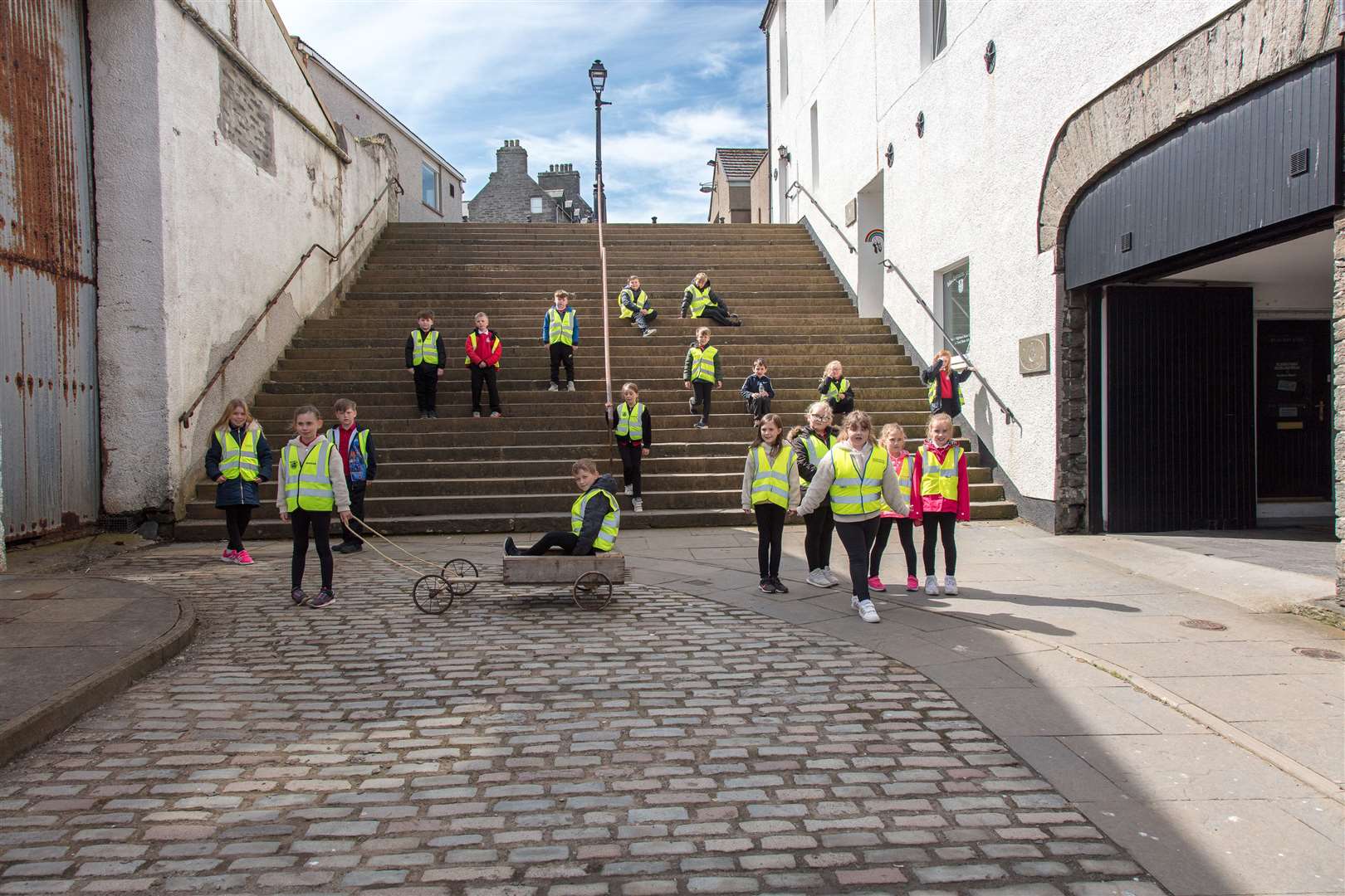Primary four pupils from Noss Primary School at the Black Stairs in Wick, recreating the scene painted by L S Lowry in 1937. Picture: Fergus Mather