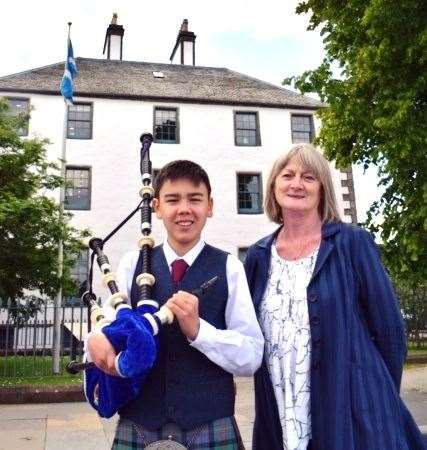 Chair of Friends of Highland Music, Moira Leslie, with young piper and FoHM grant recipient Kyle Cameron, outside Balnain House, the former Home of Highland Music.