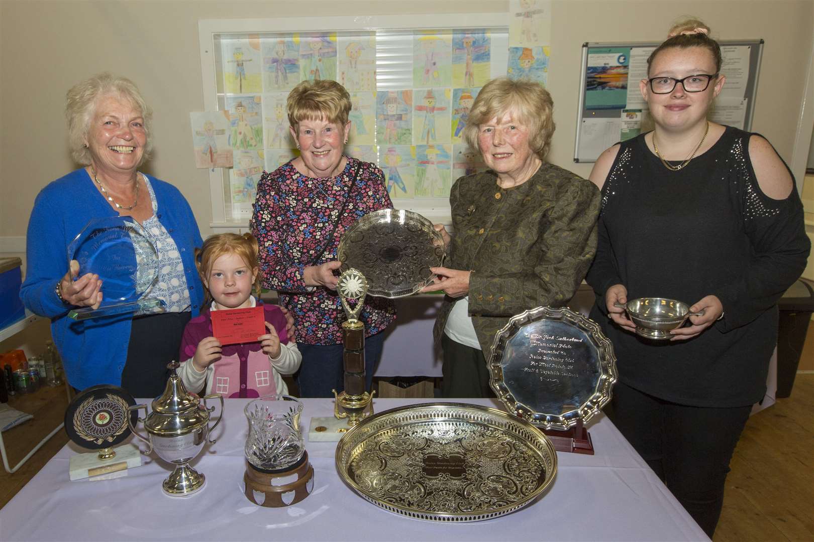 Linda Tait, (centre right), collected an armful of trophies at Reiss Gardening Club's annual show. She is seen here receiving one of her trophies from club chairwoman Annette Sinclair. Looking on are Moira Gunn, (left), who won trophies for cut flowers and floral art, Shannon Martin, (right), who had the best exhibit with a gladioli, and Ayla McAllan who won the junior prizes. Picture: Robert MacDonald/Northern Studios