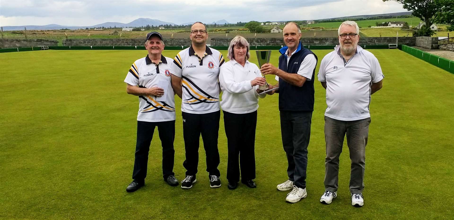 From left: Runners-up Ali Gray and Stephen Rollinson (Thurso), Fran Manners, the Lybster president, presenting the Mabbutt Open Pairs trophy to winners John Grant and Marshall Bowman (Lybster).