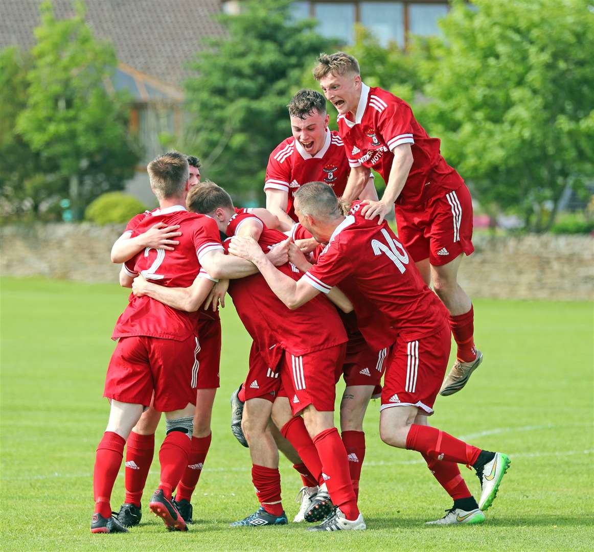 Greg Shearer is mobbed by team-mates after scoring the only goal of the Colin Macleod Memorial Cup final, three minutes into stoppage time. Picture: James Gunn