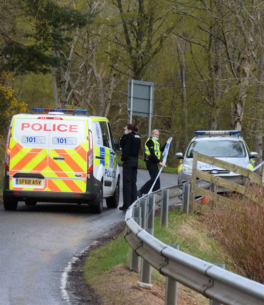 Police on the scene as the B862 remained closed following the fatal fire at a property above Dores. Picture: Gary Anthony