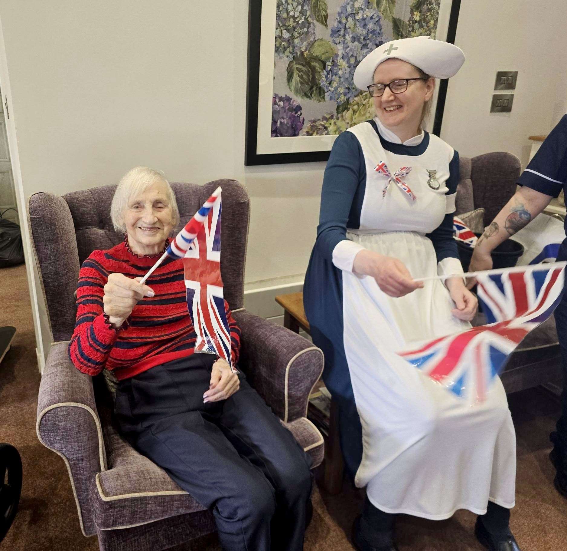 Resident Gwen Stewart and deputy manager Fiona Cameron get into the VE Day spirit during the children’s performance.