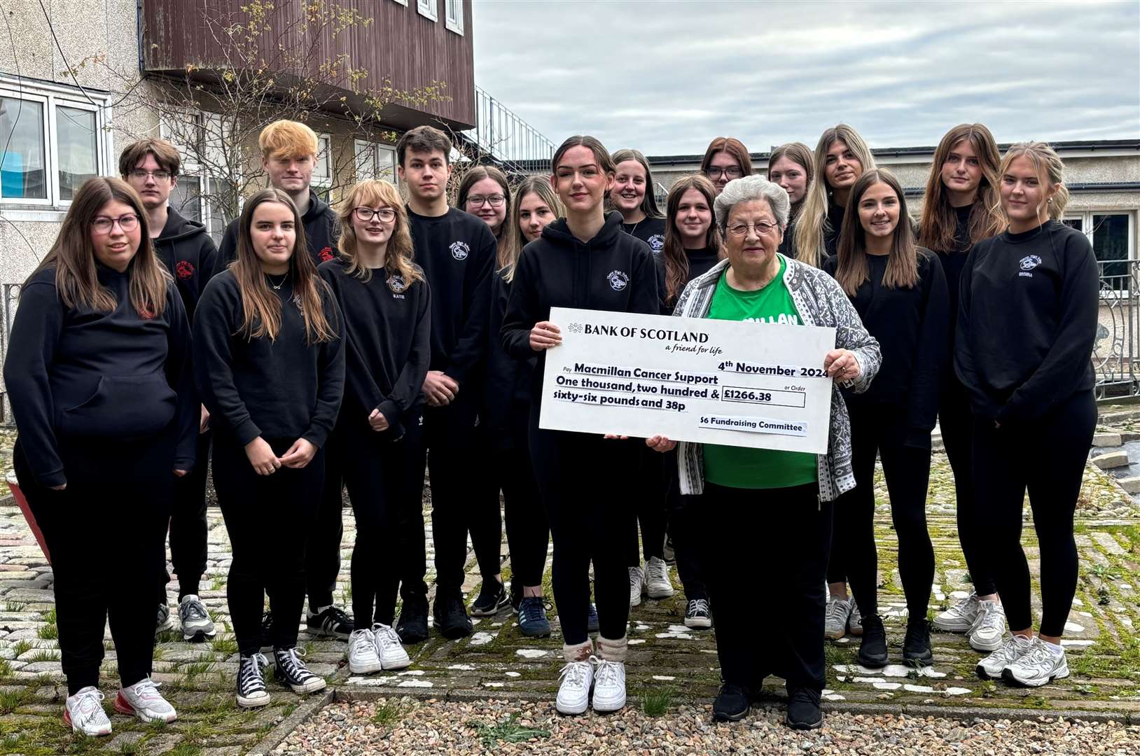 The Fundraising Committee hand over the cheque to Macmillan Cancer Support local representative, Sheila Sinclair.
