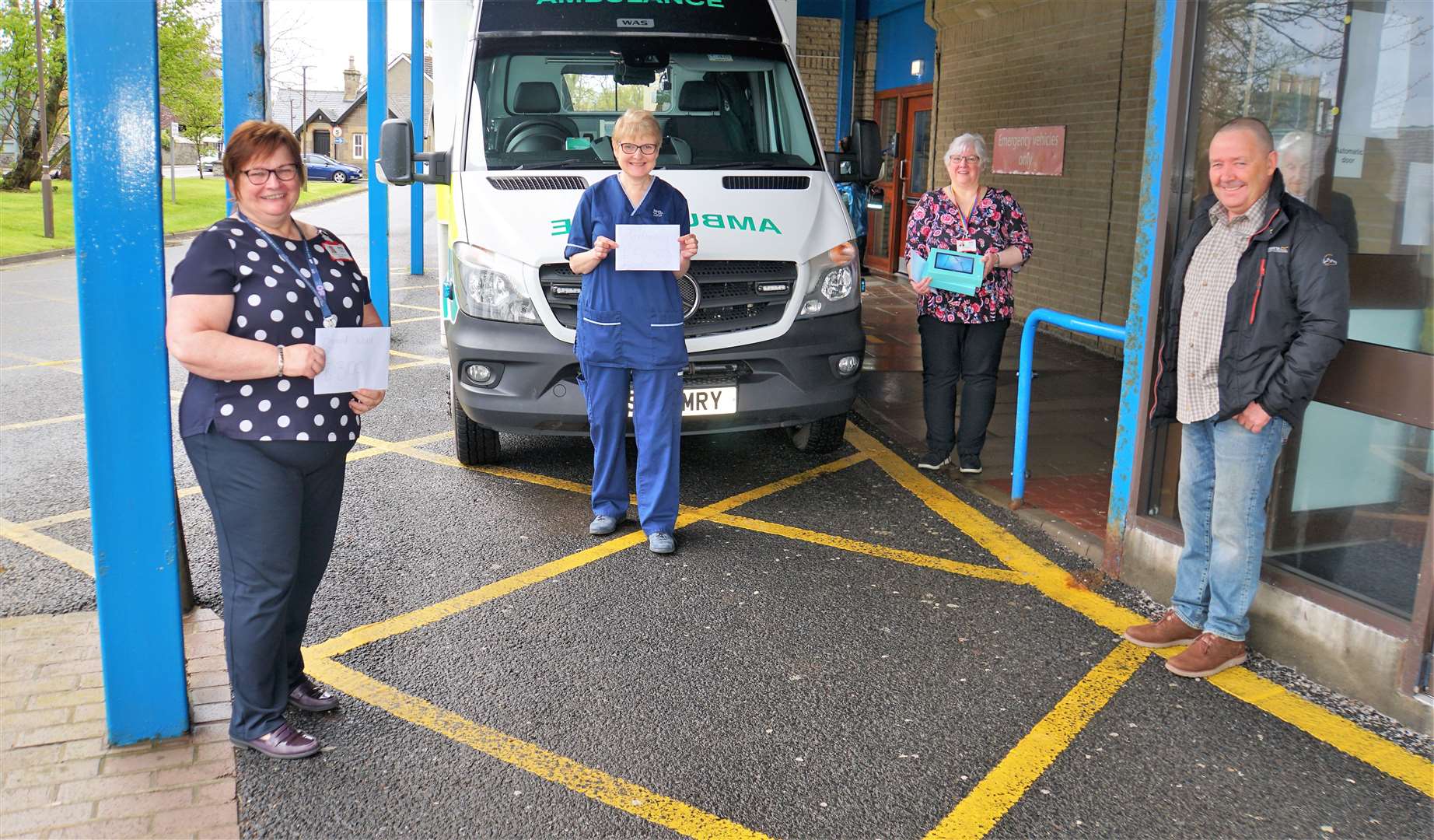 From left, NHS area support manager Kay Allan, senior charge nurse (Rosebank Wing) Pat McGee, Kay Henderson, nursing admin at the hospital, and Dennis Miller who donated the cash and tablets. Picture: DGS
