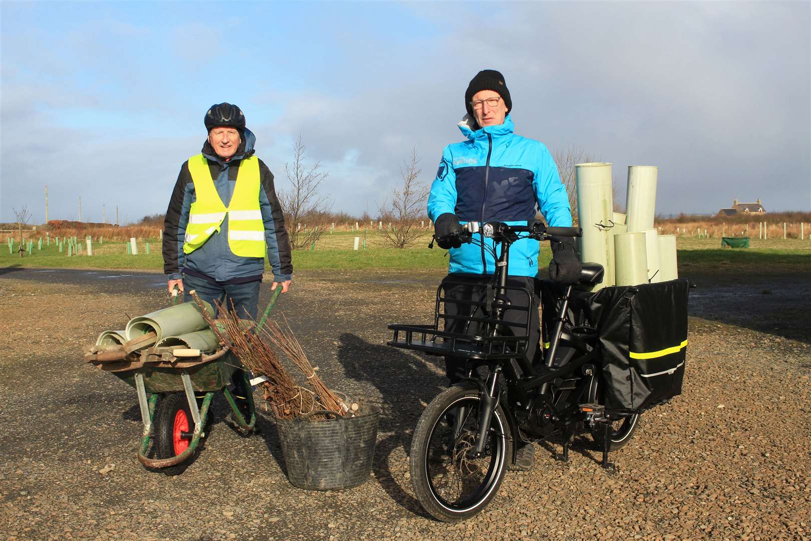 Willie Bruce (left), from Friends of Newtonhill Woodland, and George Ewing of Cycling UK in 2023 with recycled guard tubes being carried in a cargo ebike. Picture: Alan Hendry