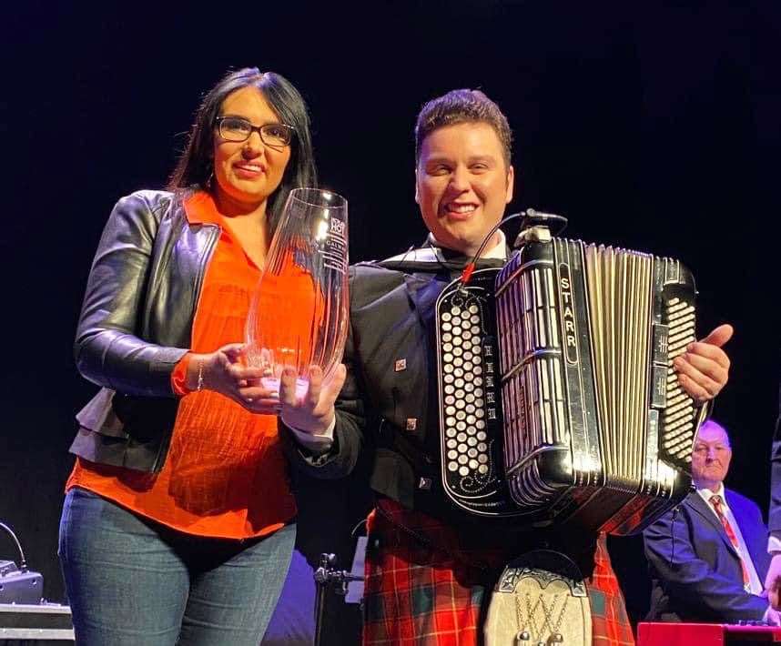 Brandon McPhee receiving the award for outstanding contribution to music from Eilish O’Sullivan of Hot Country TV at the Everyman Theatre in Cork.