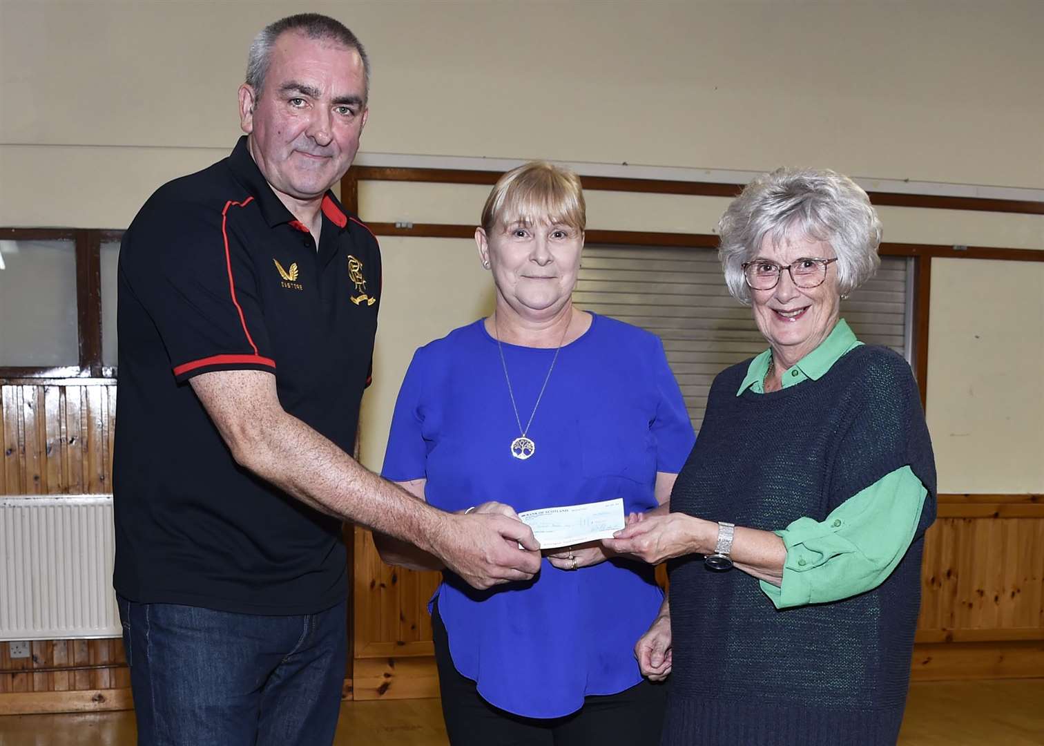 Albert Mcivor presenting a cheque for the North Highland Cancer Information and Support Centre. Picture: Mel Roger
