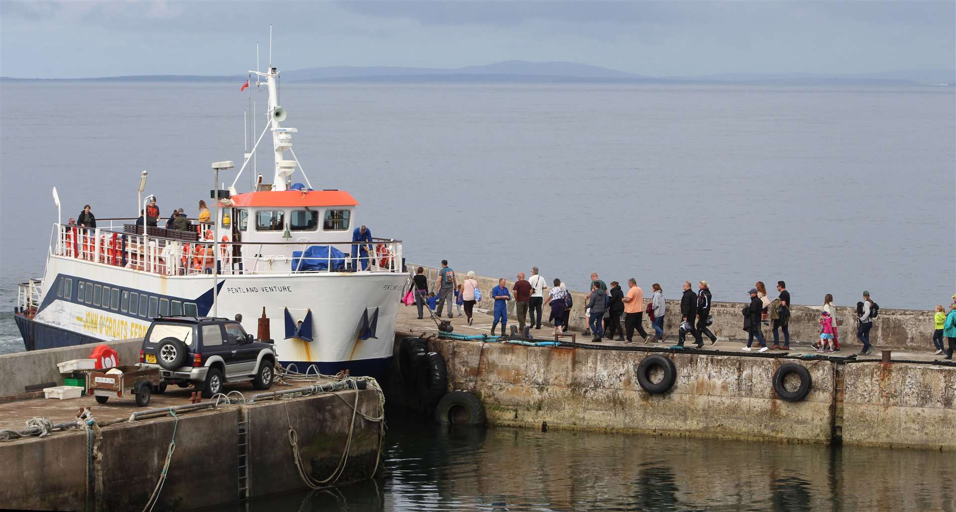 Passengers making their way onto the Pentland Venture at John O'Groats harbour in August 2018. Picture: Alan Hendry