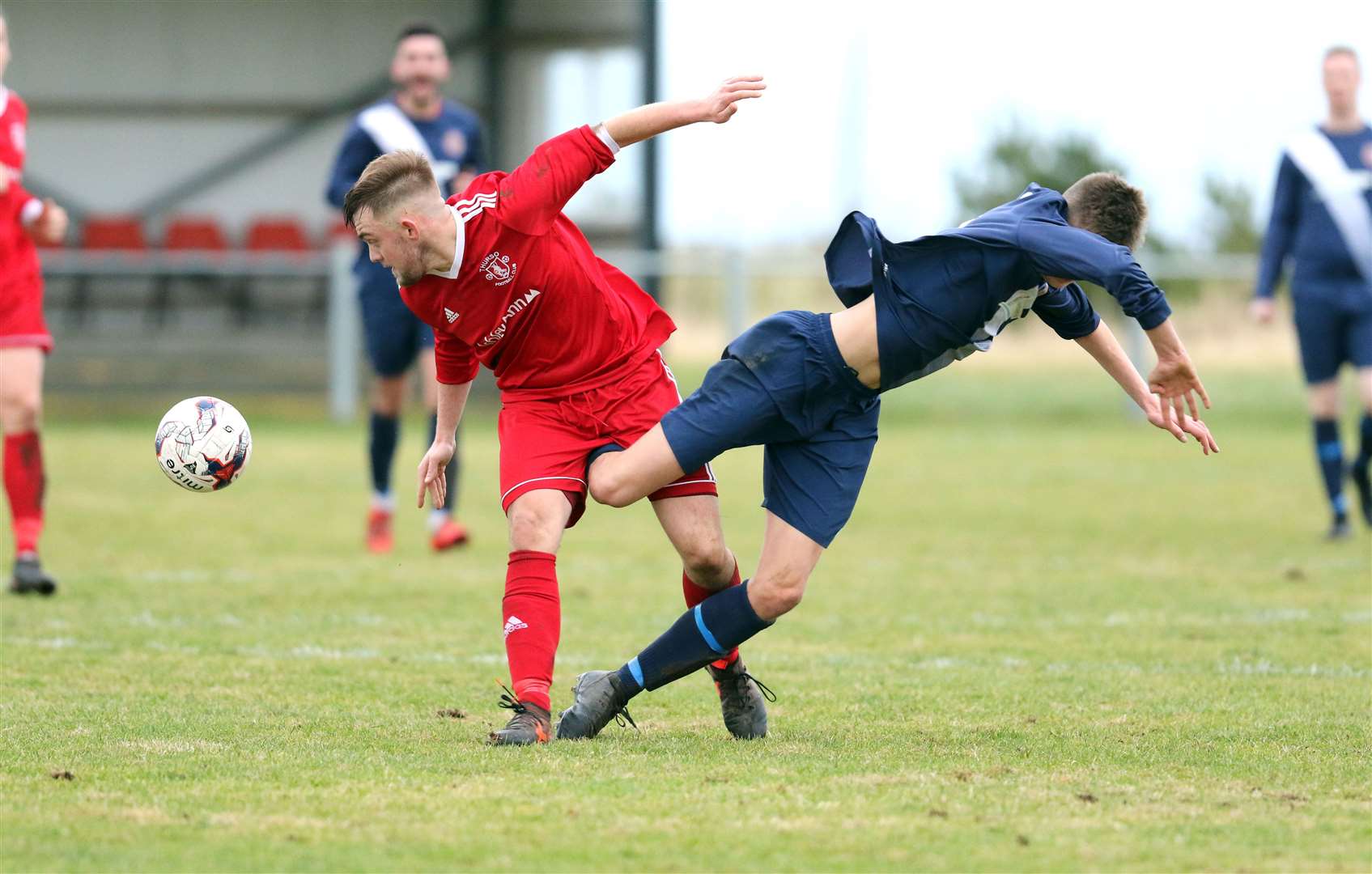 Thurso's Luke Manson in a painful tangle with Halkirk United's James Mackintosh during the derby clash at Morrison park. Picture: James Gunn