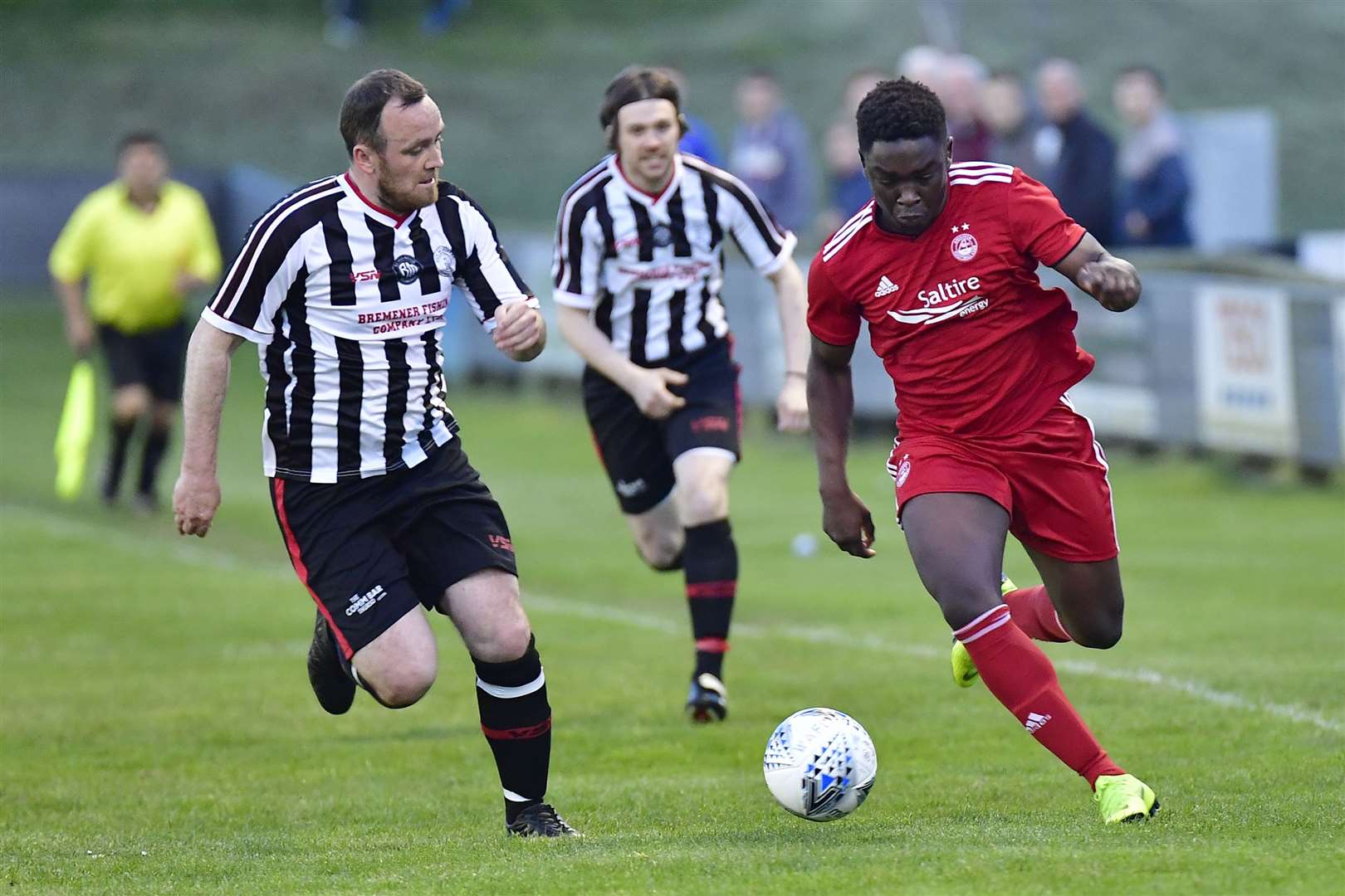 Aberdeen's David Dangana is tracked by Wick Academy veterans Stewart Ross and Shaun Sinclair, who were among the many second-half substitutes in the Richard Macadie testimonial match. Picture: Mel Roger