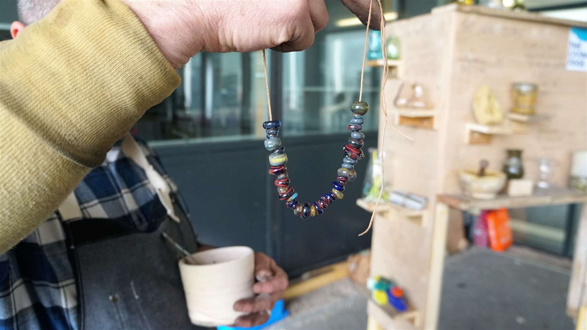 Michael Bullen shows of the glass beads he has created. Picture: DGS