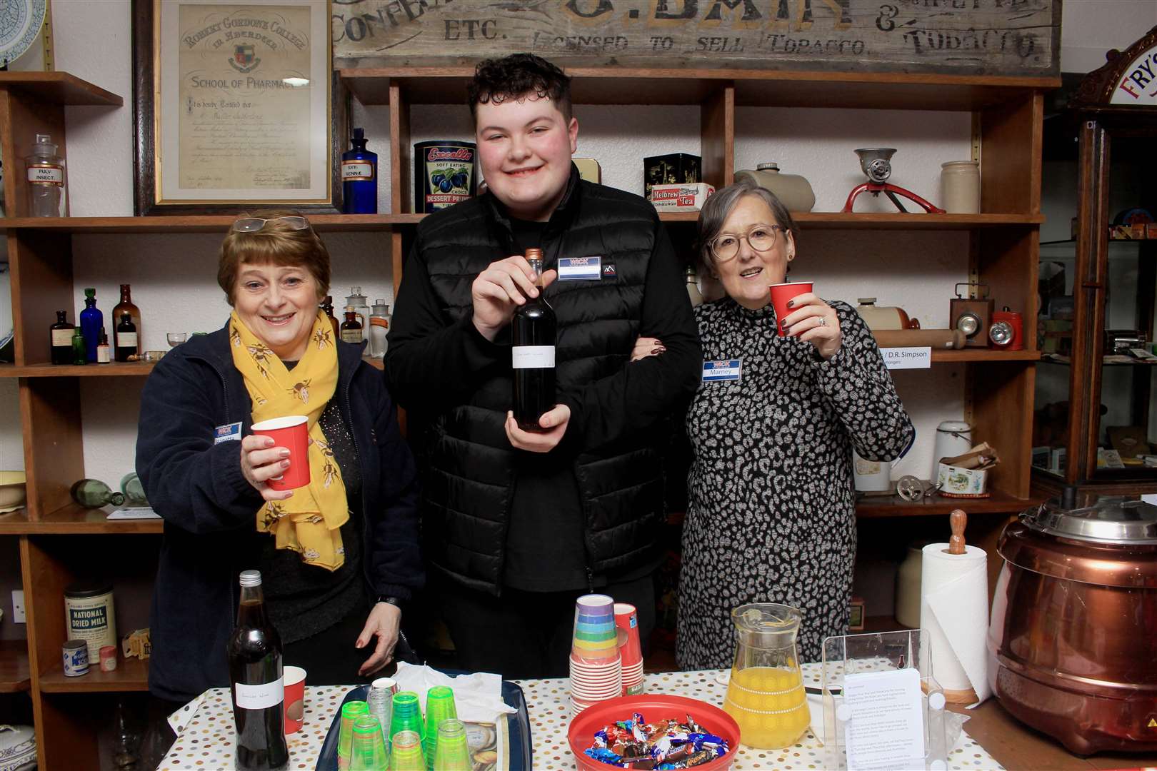 Wick Society volunteers Jeanette Coghill, Scott Mackenzie and Marney Bruce were offering non-alcoholic mulled wine, ginger wine, orange juice and sweets. Picture: Alan Hendry