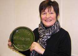 Retailer Doreen Turner with the plaque she commissioned when her shop moved from Bridge Street to High Street 33 years ago.