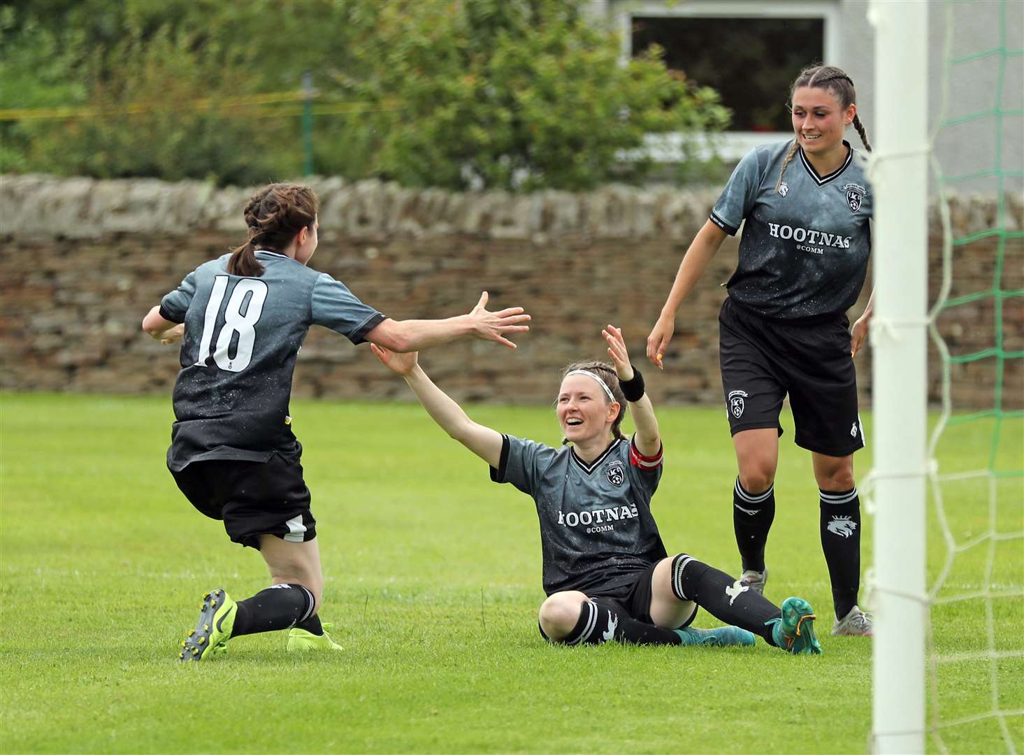 Captain Carly Erridge (sitting) celebrates with Sophie Kinghorn (left) and Sarah Henderson after scoring one of her two goals in the Highlands and Islands Cup semi-final against Sutherland. Picture: James Gunn