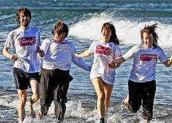 A group emerging from the sea at last year's dip.