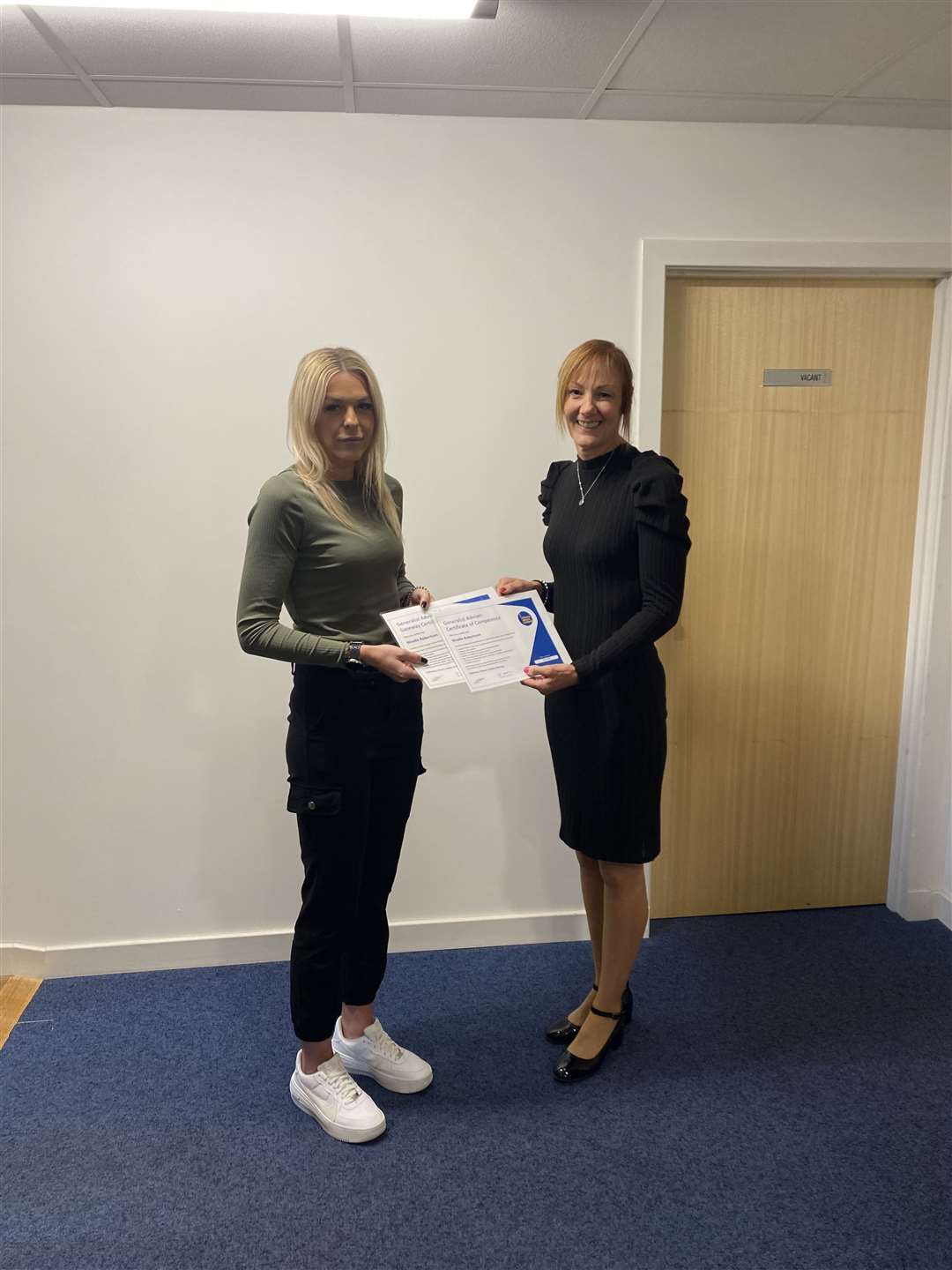 Jane MacIntosh (right) presents Nicolle Robertson, a newly trained CAB adviser, with her certificates.
