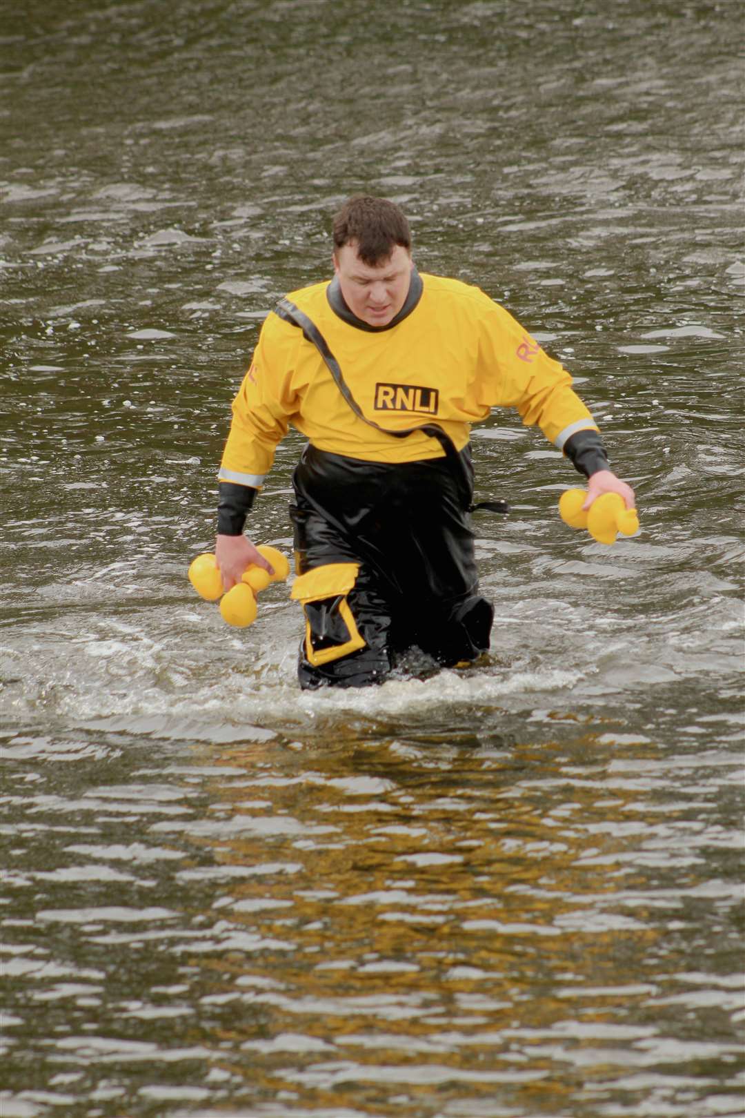 Lifeboat mechanic Johnny Grant retrieving some of the ducks at the end of the race. Picture: Alan Hendry