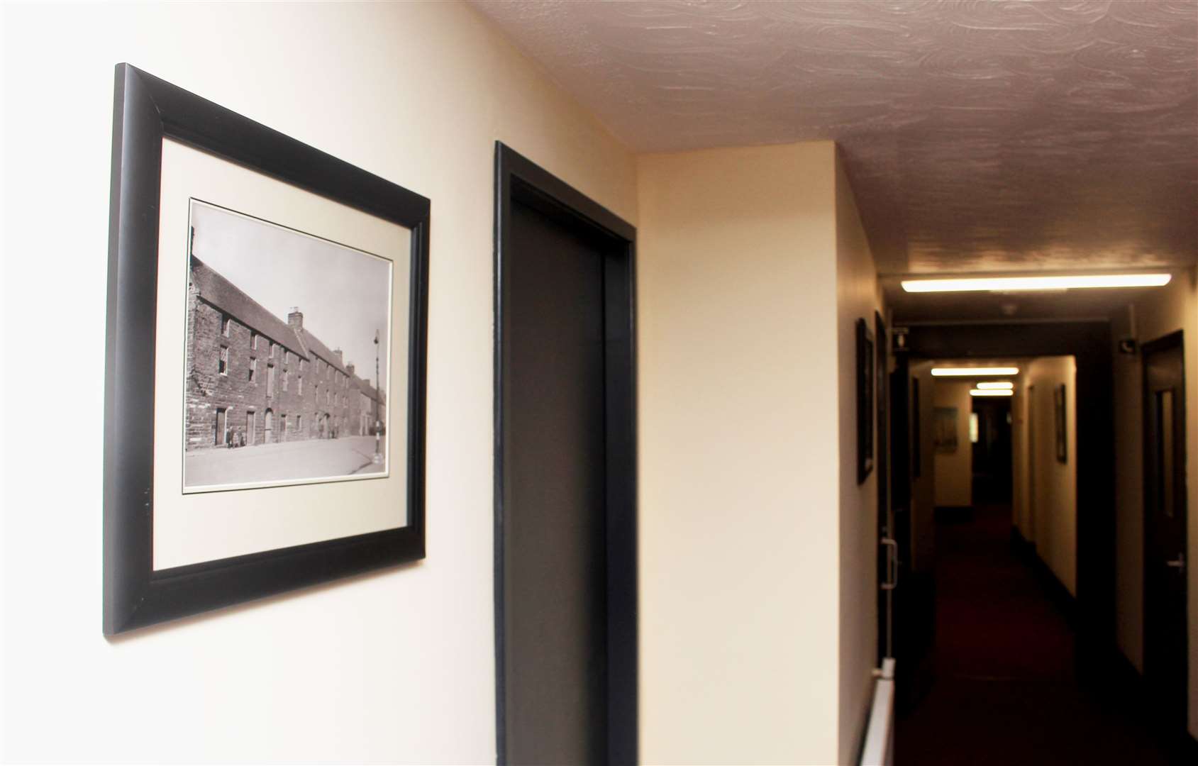 Framed prints from the Johnston photographic collection in a downstairs corridor. Picture: Alan Hendry