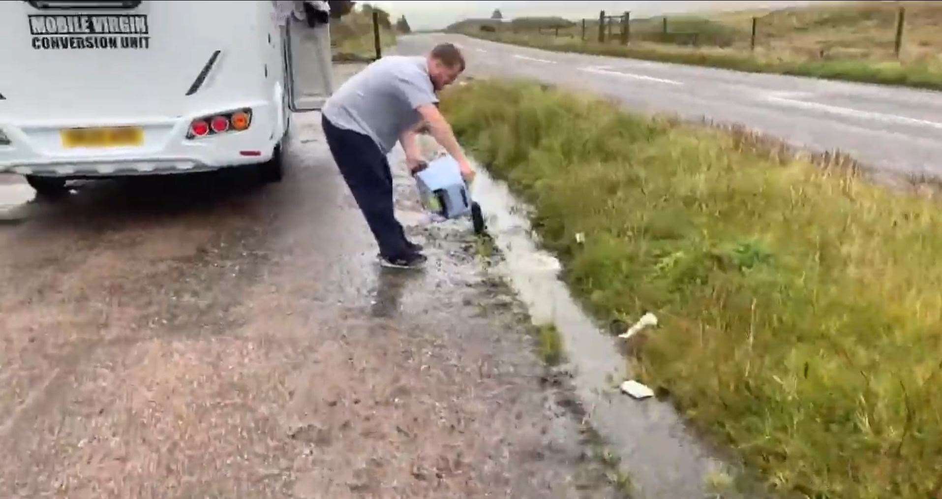 This still taken from the video shows one of the motorhome occupants upending the chemical toilet cassette.