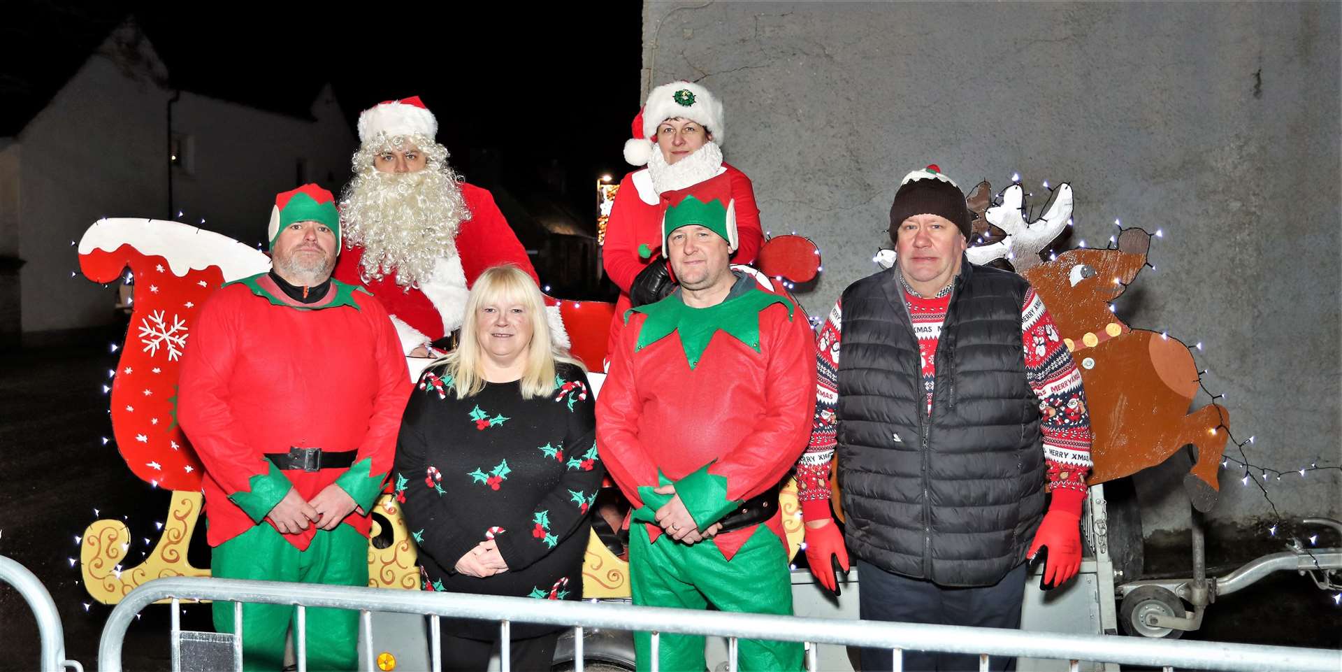 Santa and his helpers. From left, Mark Budge, Alastair Budge, Mandy MacDonald (who donated the sweets along with Martin Munro). Fiona Budge, Iain MacKenzie, and Alec Budge. Picture: James Gunn