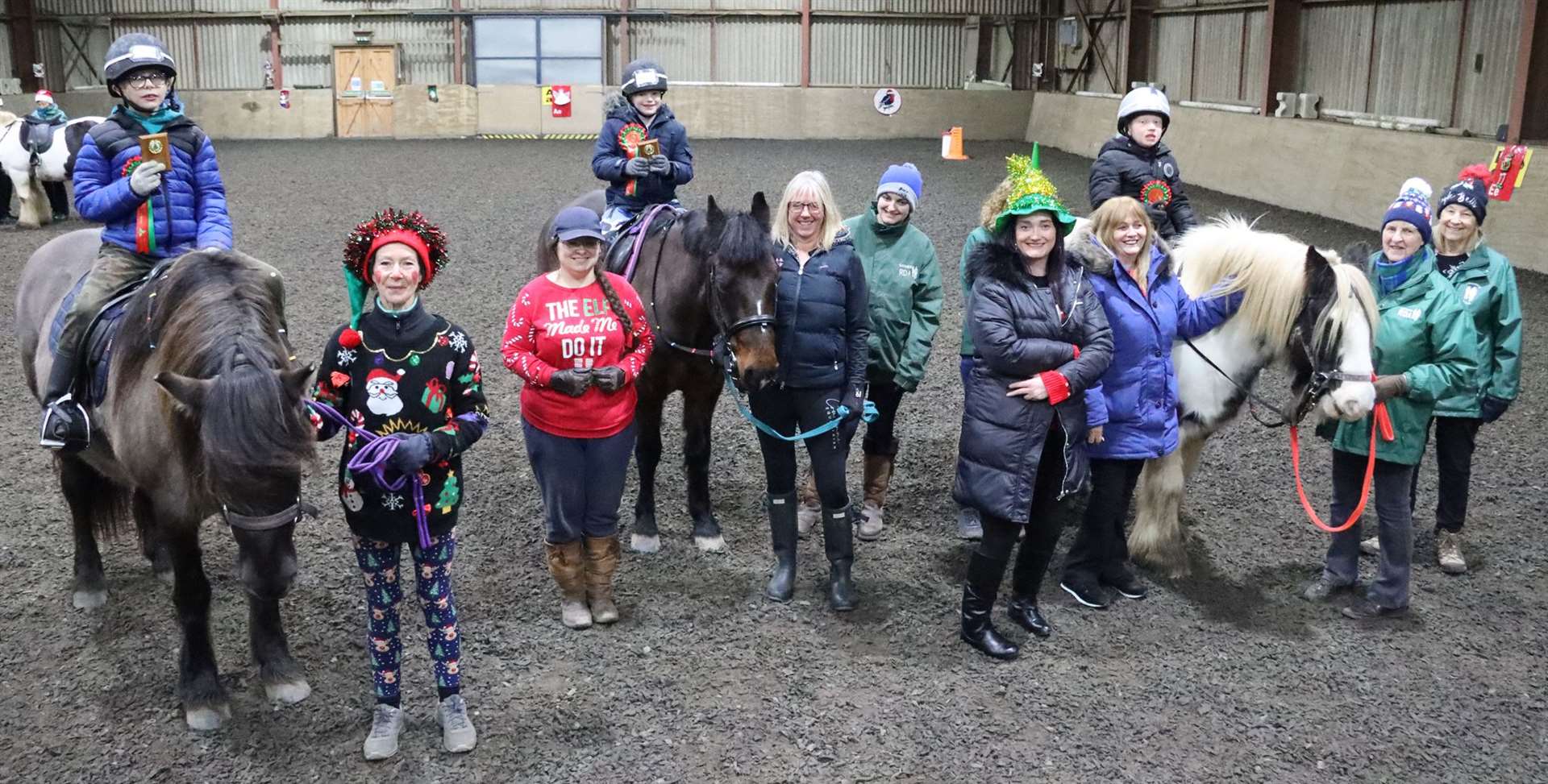 Ride 2 with coach Steph Cowe in her red Christmas jumper (third left). The presentation of trophies and rosettes was made by Heather Rosie and Claire Fraser (fourth and fifth right) from the Dale Rosie Memorial Fund. Picture: Neil Buchan