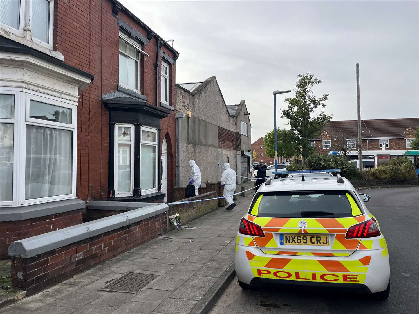 Two forensics officers enter a cordoned off property in Wharton Terrace, Hartlepool (Tom Wilkinson/PA)