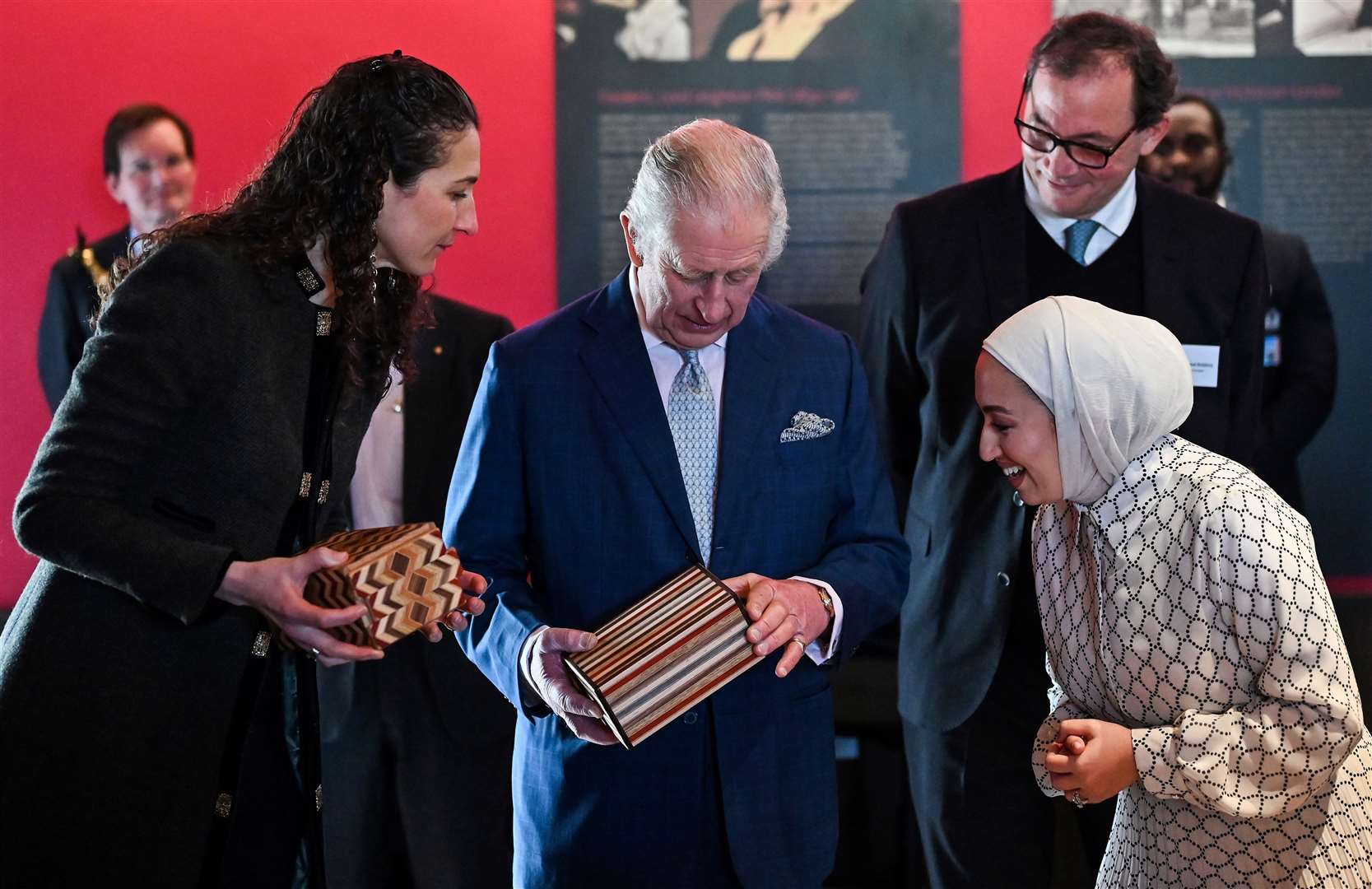 The King attempts to open a puzzle box made in Jordan during a visit to the newly renovated Leighton House museum in London (Justin Tallis/PA)