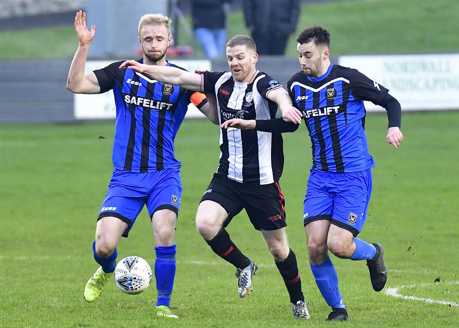 Wick's Davie Allan is sandwiched between Huntly's Ross Still and Liam MacDonald during the Scorries' 3-0 Highland League Cup exit. Picture: Mel Roger