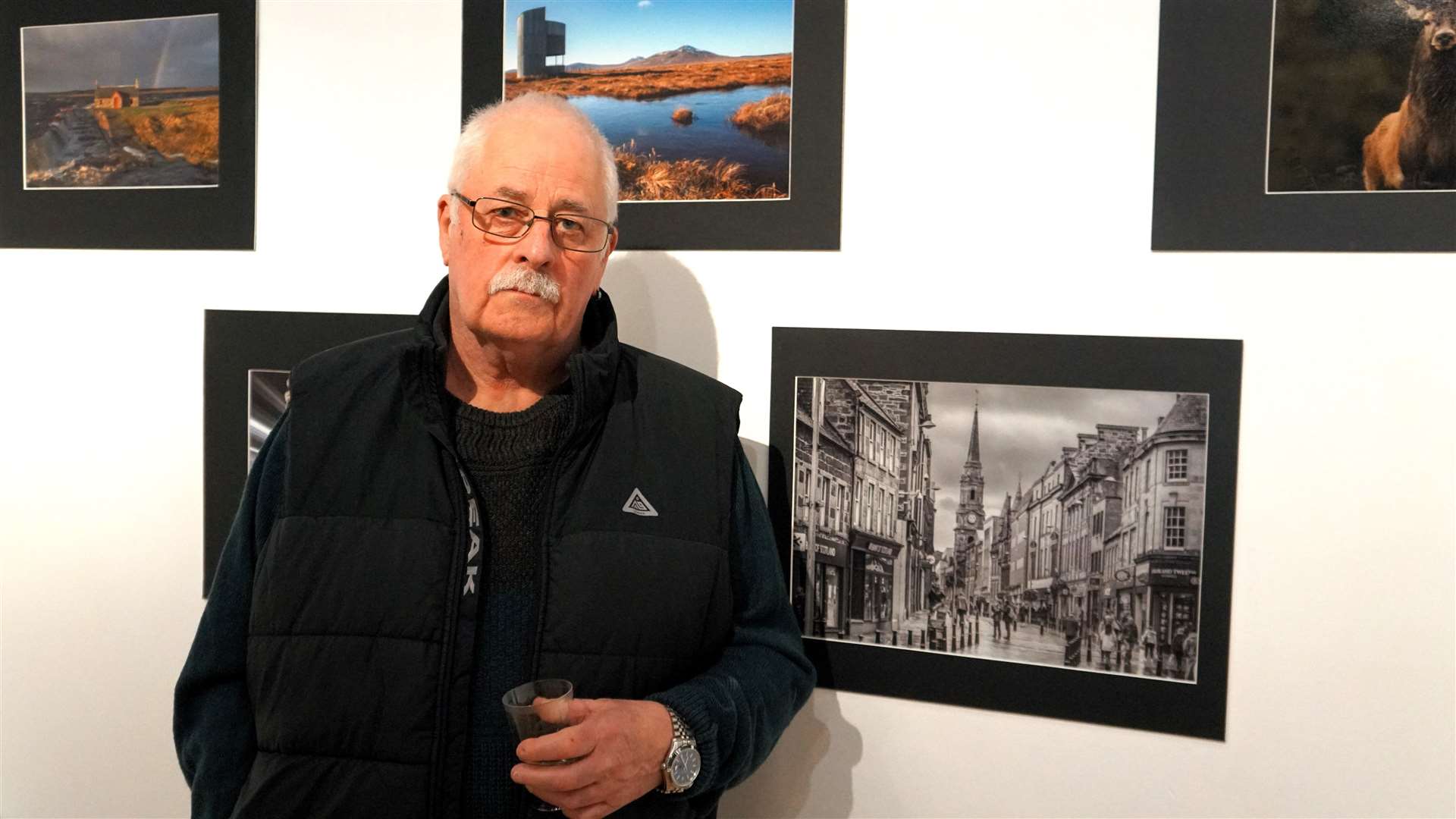 Local photographer Neil Holden beside a striking image he took of Inverness city centre. Picture: DGS