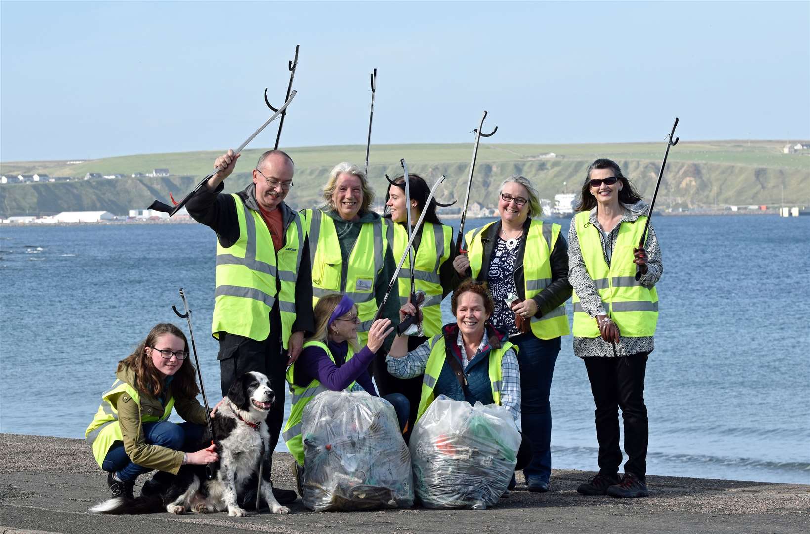 Dorcas Sinclair, second from left at back, celebrates with other members of Caithness Beach Cleans as they hold up their new litter-pickers.