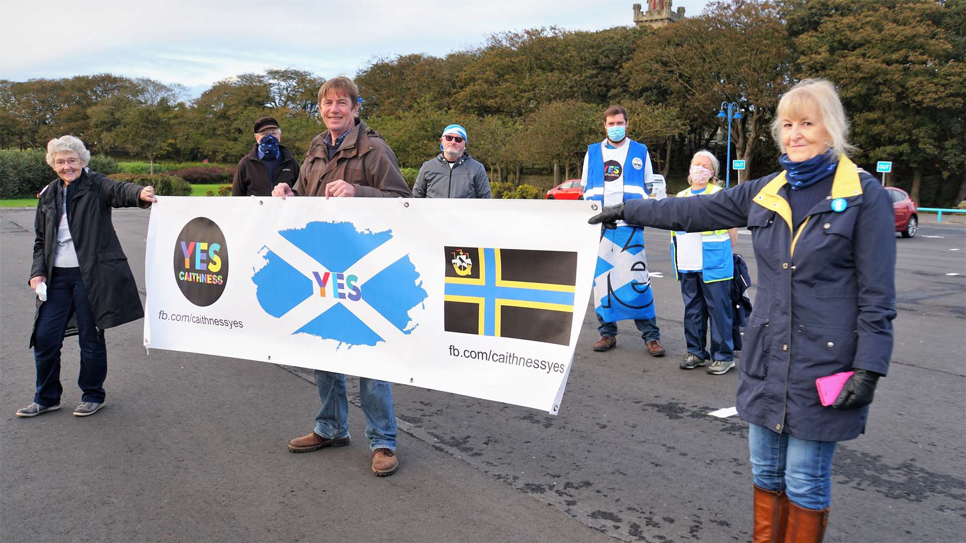 Walkers Iain Leckenby and Ever Uan Beag, at rear right, along with some of their supporters at Wick's riverside car park. Picture: DGS
