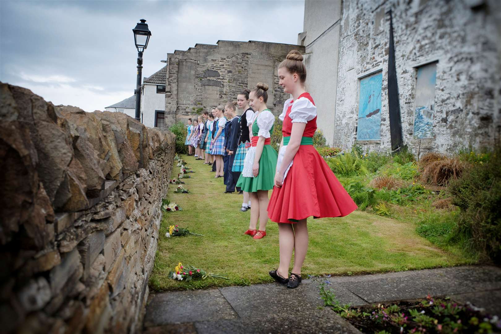 Members of the the Elise Lyall School of Dance placing flowers in the World War II memorial garden on Saturday. Picture: Brian Hamilton