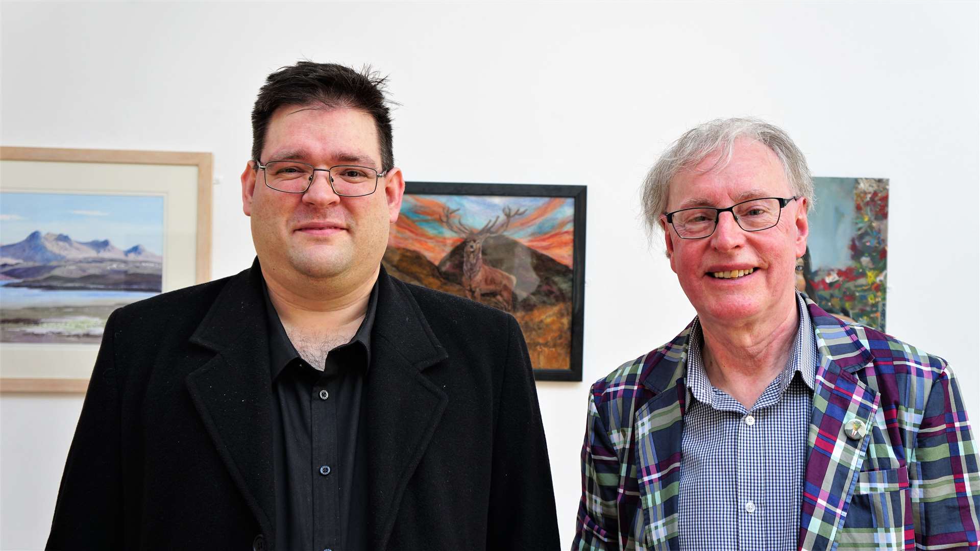 Bobby McCarthy, at left, who helped hang the artworks alongside Ian Pearson who is chair of the Society of Caithness Artists. Picture: DGS