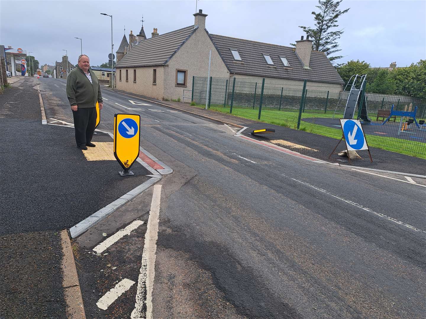 Billy Dunbar at the crossing on the Main Street. The two bollards on the right hand side of the road have been knocked down.