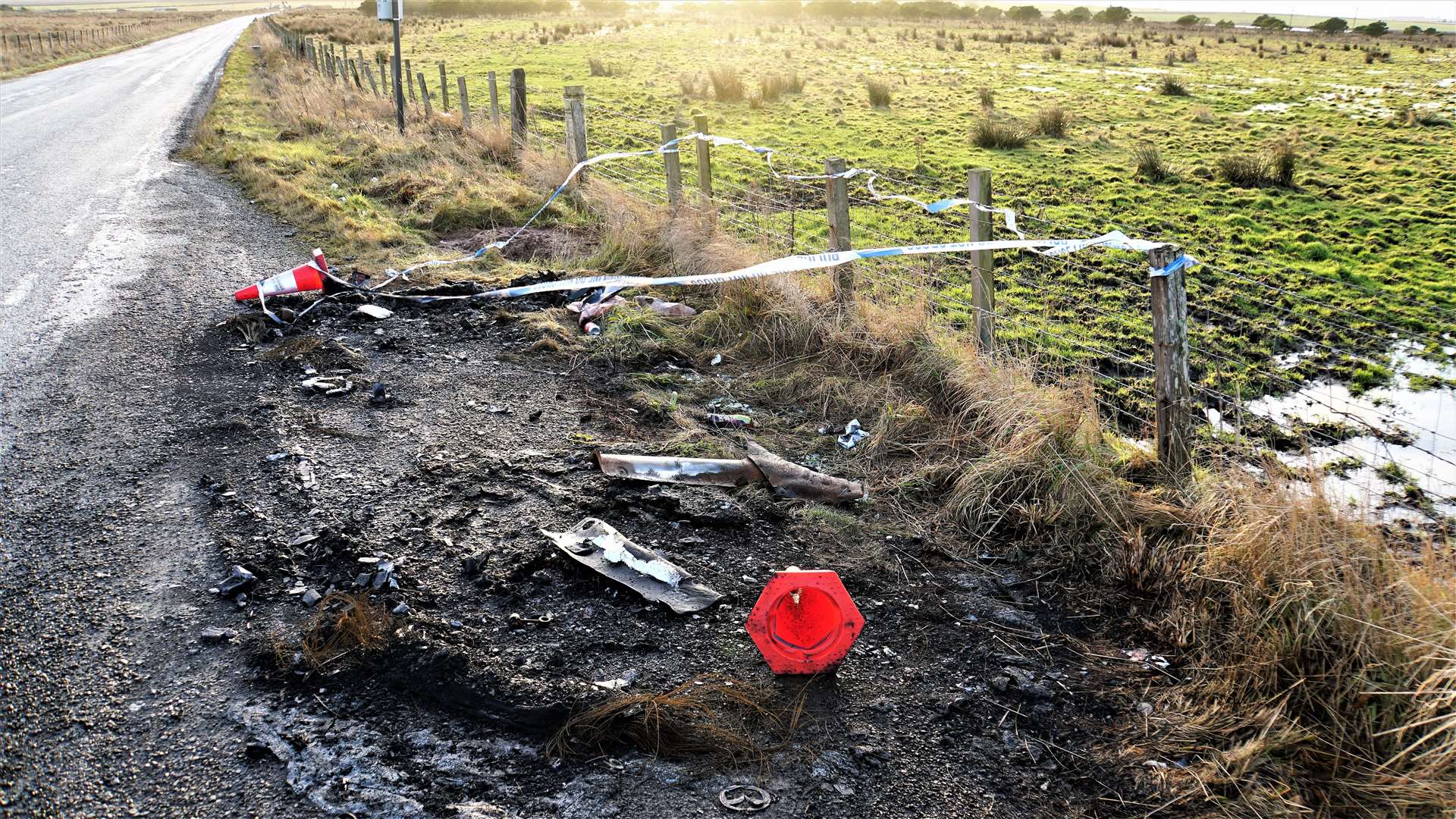 The lay-by on the A99 after Saturday night's blaze. Police tape surrounds a burnt area where the car sat for six months. Picture: DGS
