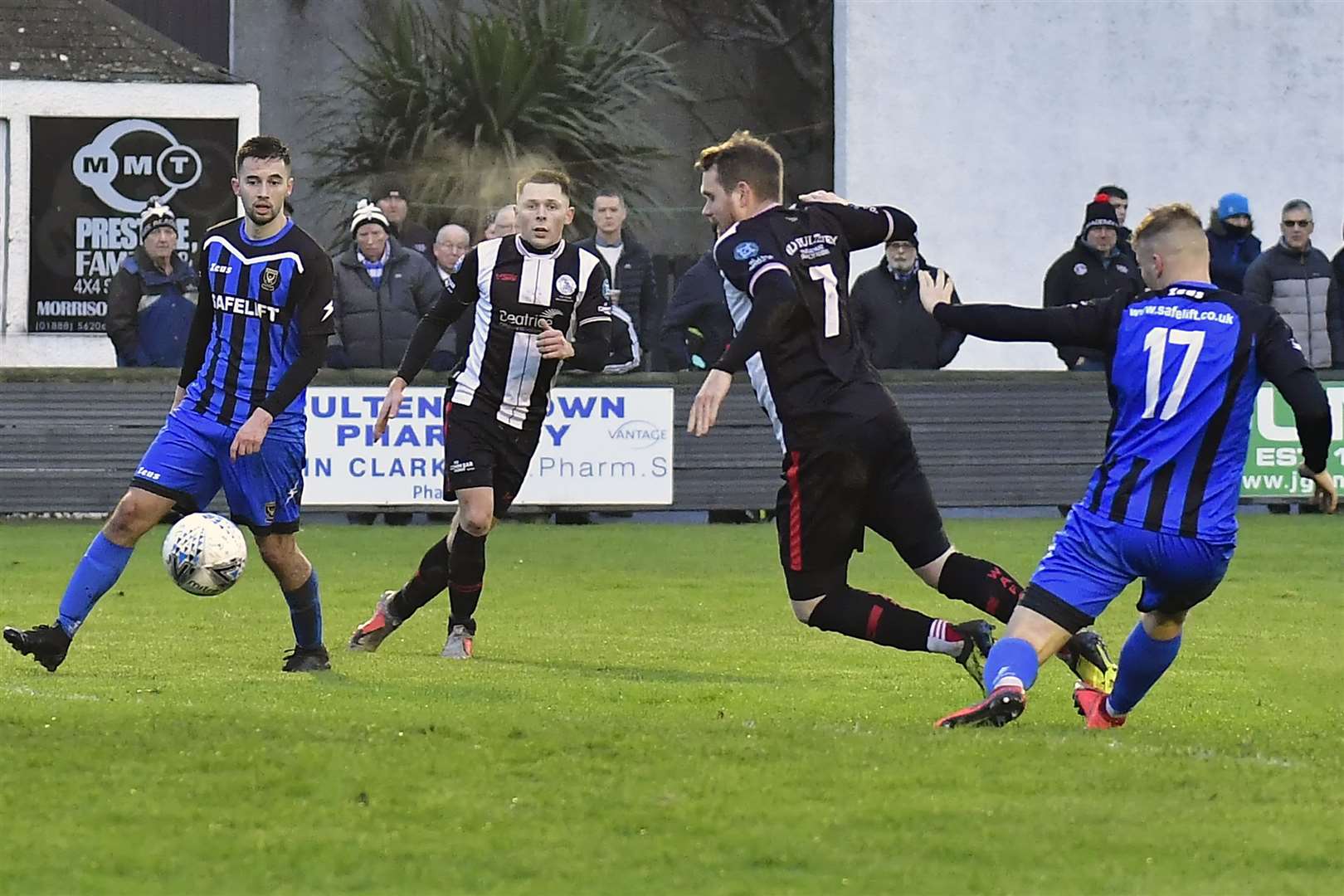 Wick Academy's Craig Gunn goes down inside the box following a challenge from Huntly's Ashley Ballam. Wick were denied a first-half penalty which Huntly took advantage of as the Aberdeenshire side won 3-0. Picture: Mel Roger