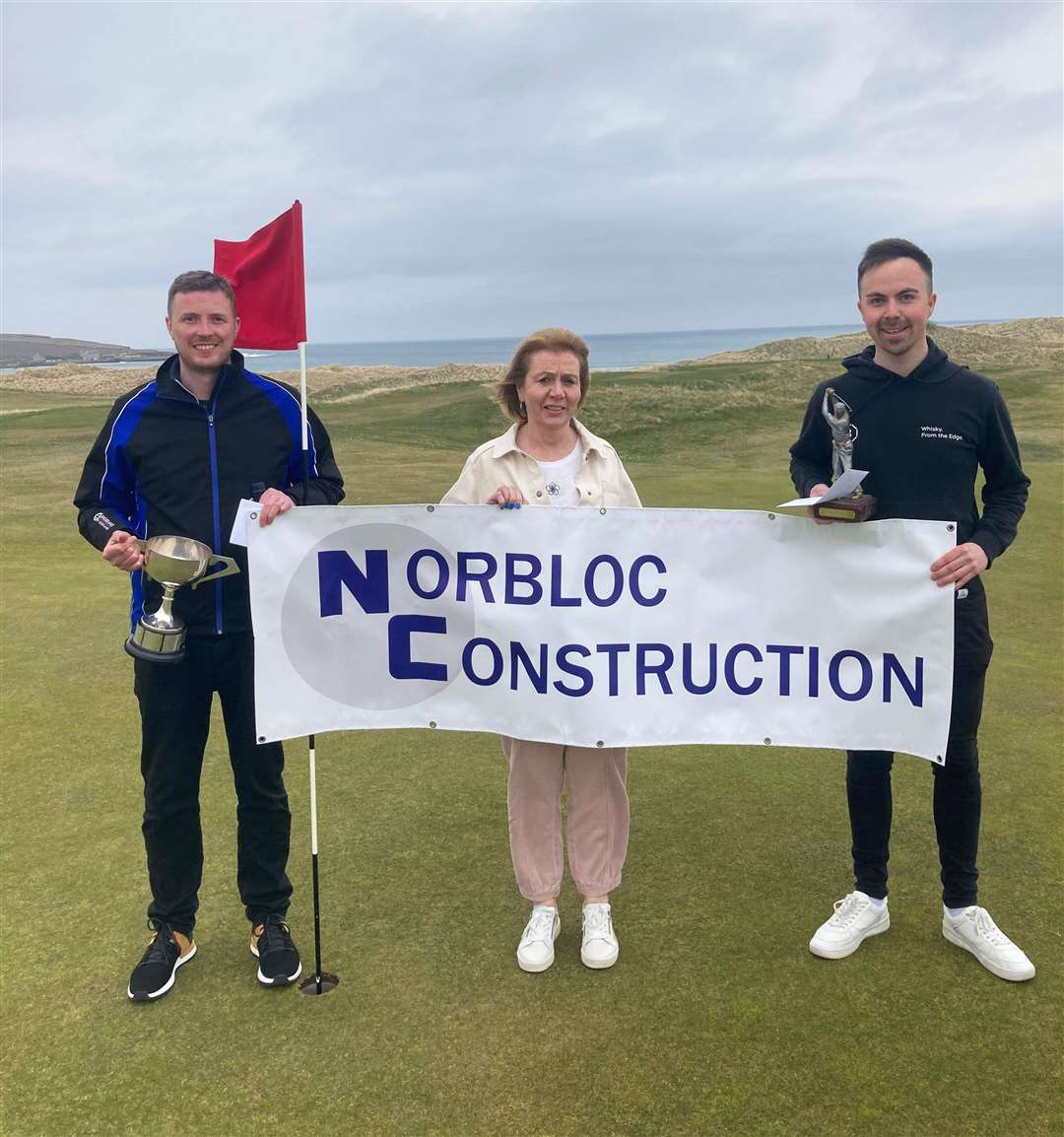 Lee Malcolm (left), overall winner in Reay Golf Club's recent Ronnie Wallace Open, sponsored by Norbloc Construction, and scratch winner Gregor Munro (right), with Trish Bremner from Norbloc. Lee also won a bottle courtesy of Rock Rose gin for nearest the pin at the 18th.