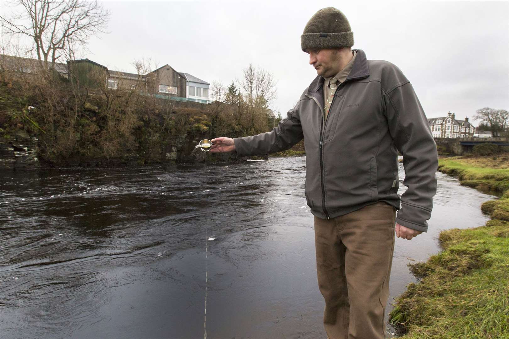 Senior ghillie Geordie Doull toasts the River Thurso at the opening of the 2024 salmon season. Picture: Robert MacDonald / Northern Studios