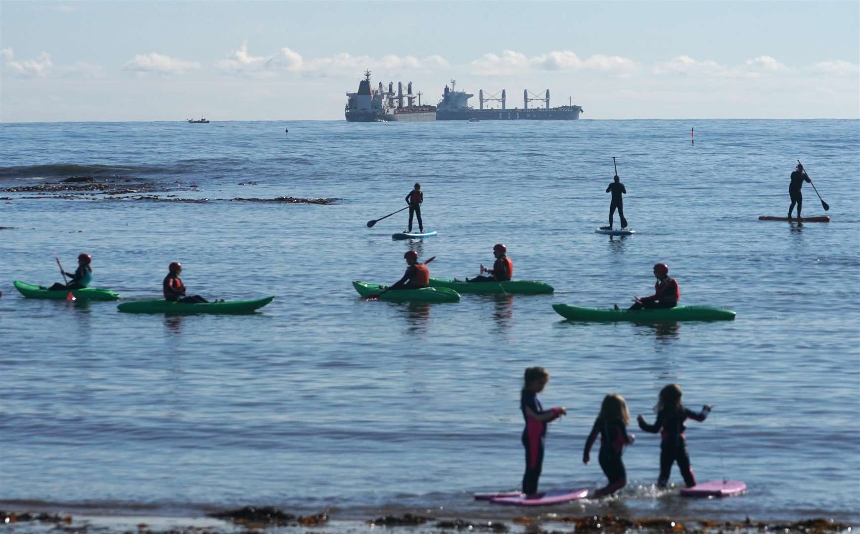 Kayakers and paddleboarders at Cullercoats Bay, North Tyneside (Owen Humphreys/PA)