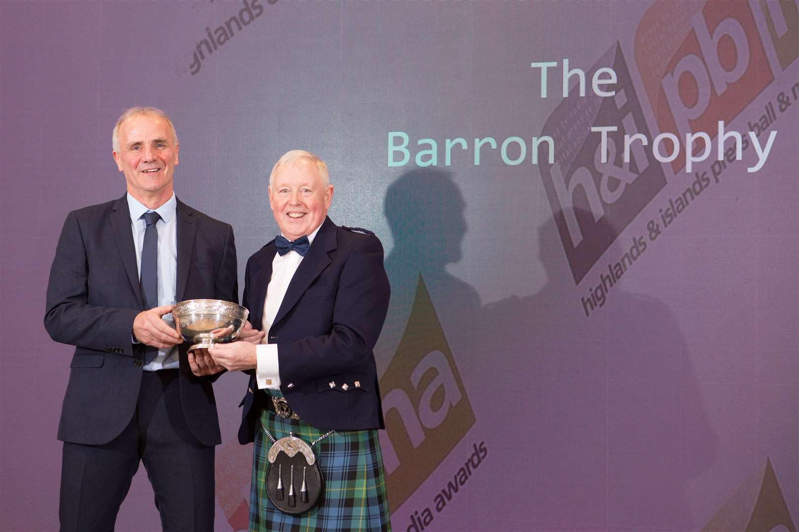 Iain Grant (left) receiving the Barron Trophy from Gordon Fyfe, chairman of the Highlands and Islands Media Awards, at Friday's event in Inverness. Picture: Alison White