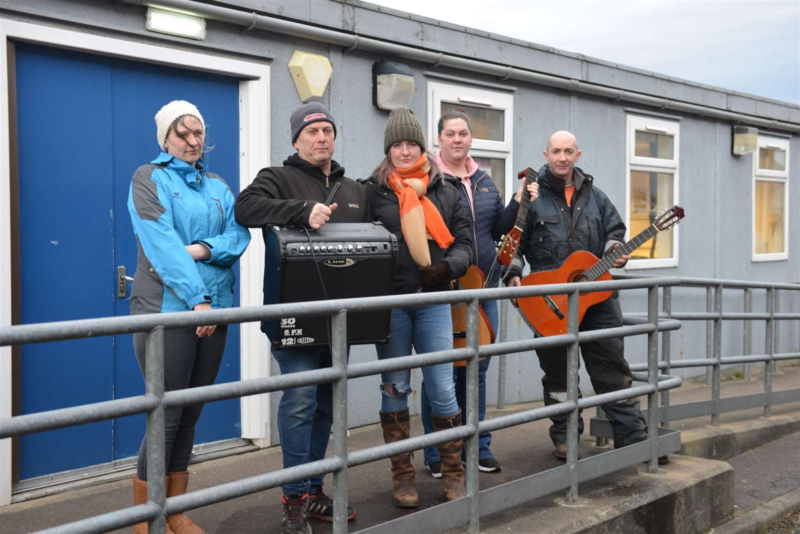 Parents (from left) Stephanie Rice, Gary Munro, Joanna Mackenzie, Carly Simpson and Andy Maclean at the music hut with some of the damaged equipment. Amplifiers were ruined by damp, ukeleles had to emptied of water, metal strings wee rusted and guitars were distorted by damp.