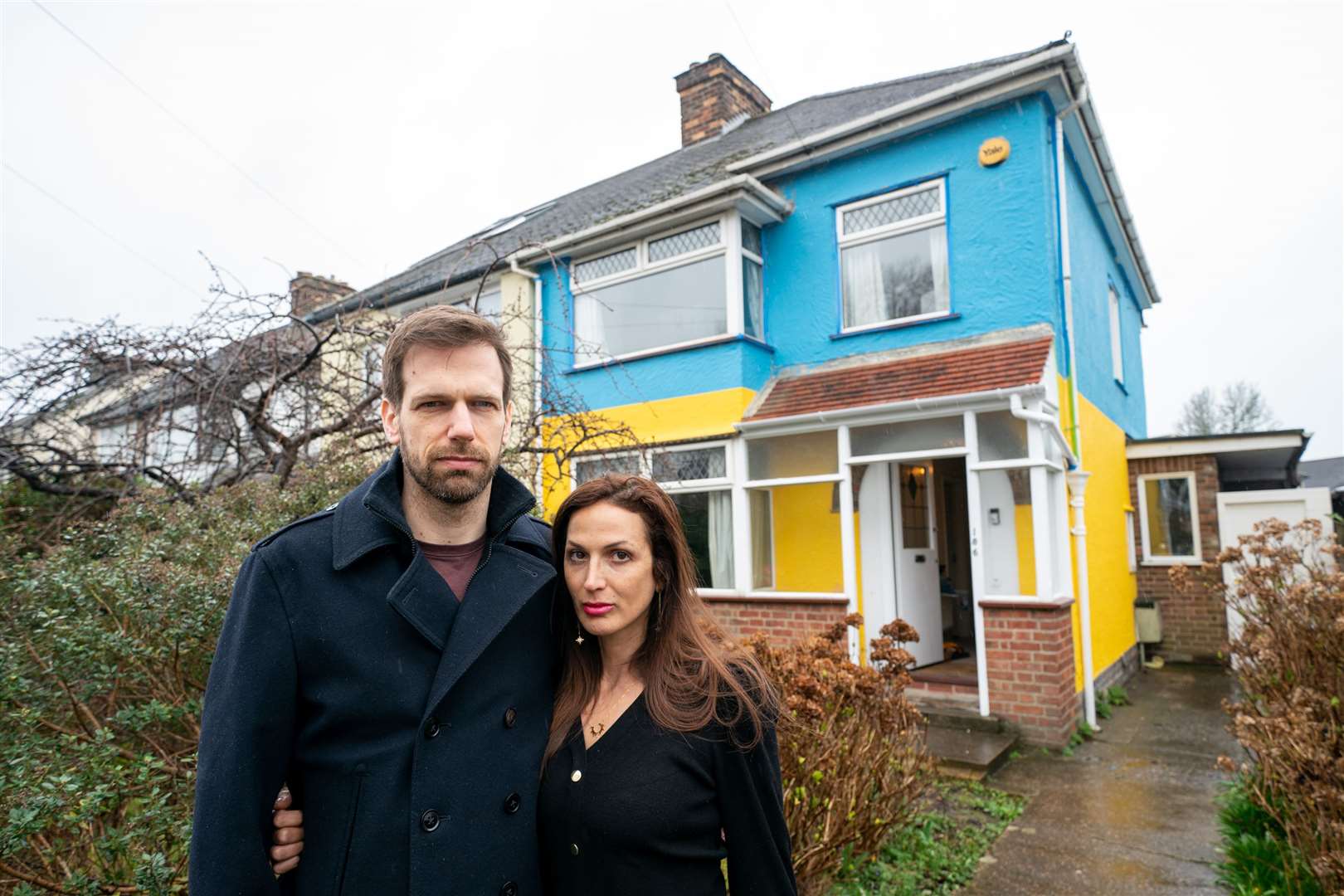 Rend Platings and her husband Michael outside their home in Cambridge, which they have painted in the colours of the Ukraine flag in a show of support for friends in the country. (Joe Giddens/ PA)
