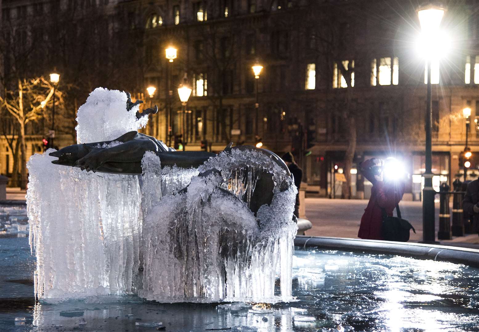 People look at the frozen fountains in Trafalgar Square (Ian West/PA)