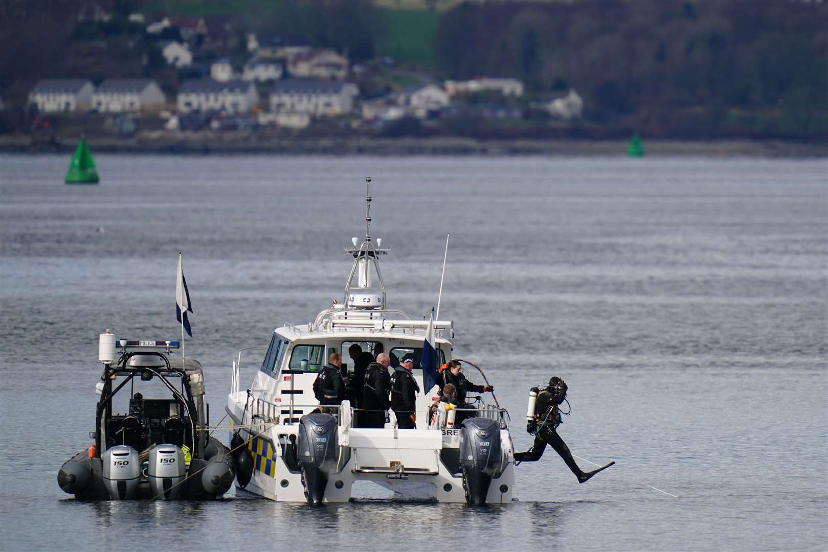 Police boats and divers taking part in the rescue operation in the Firth of Clyde (Jane Barlow/PA)