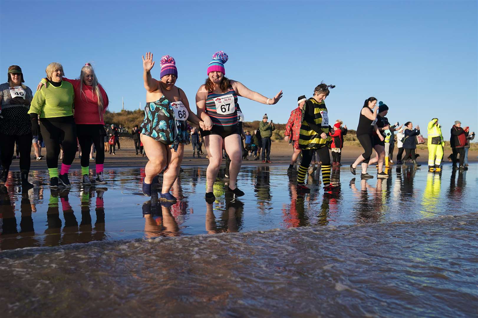 People take part in the Mablethorpe Big Dip in Lincolnshire (Joe Giddens/PA)