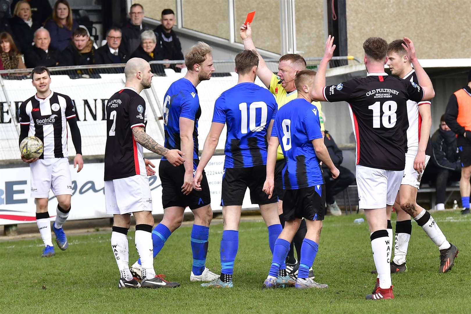 Referee Alan Proctor shows the red card to Wick Academy's Sean Munro. Picture: Mel Roger