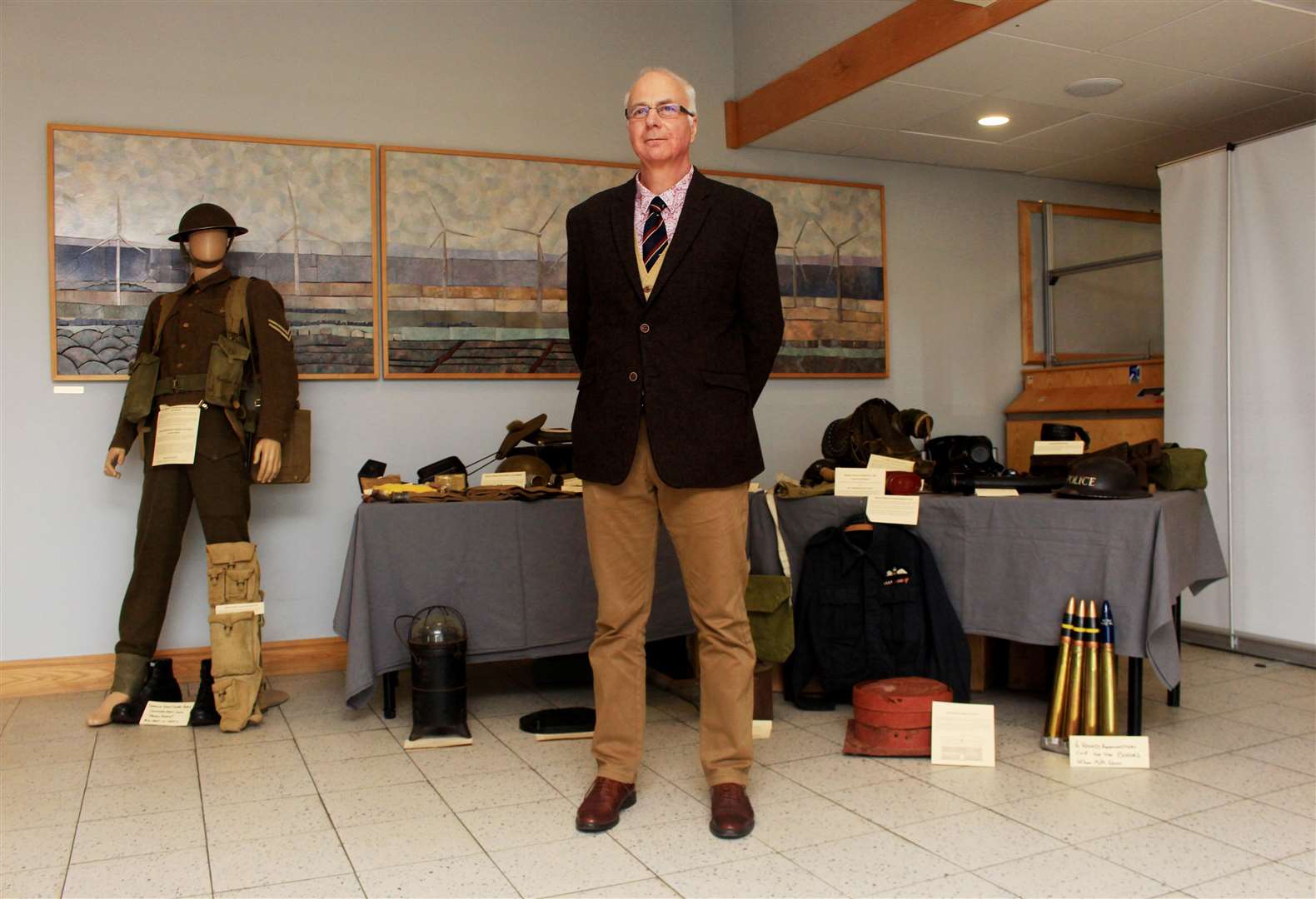 Andrew Guttridge, a member of the Caithness At War steering group, beside a display of his wartime memorabilia that was set up in Wick John O'Groats Airport for Saturday's launch event. Picture: Alan Hendry