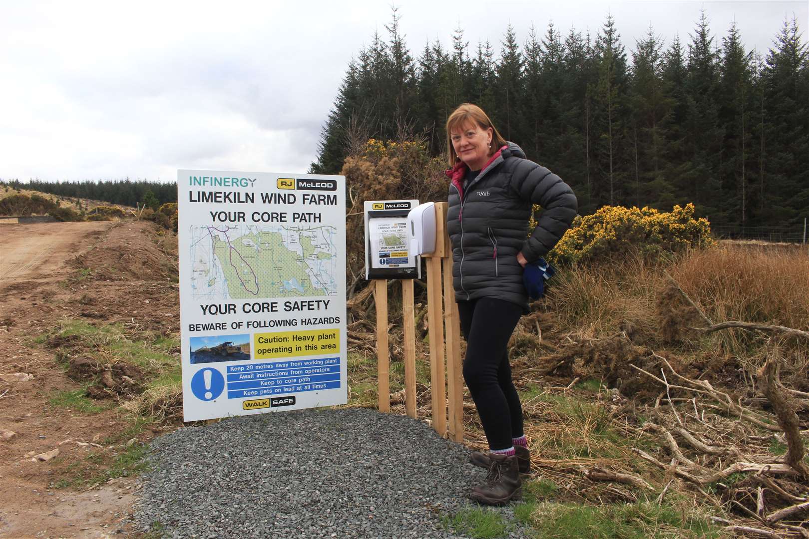 Jillian Bundy at a gate to Limekiln Forest where members of the public can pick up a laminated guide to the core path.